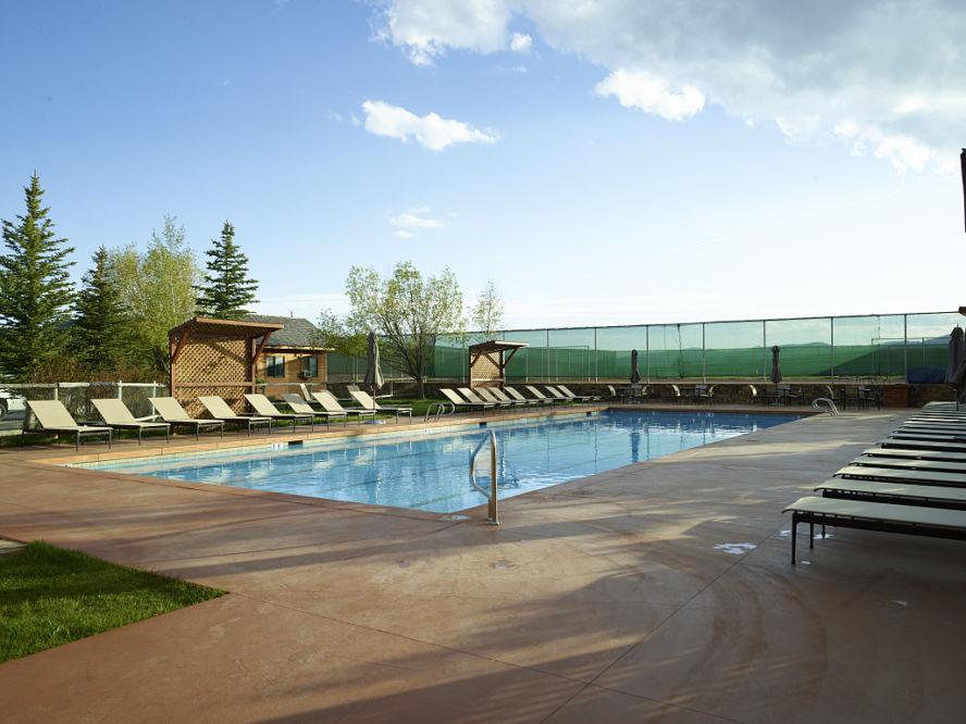 An in-ground swimming pool on a sunny day.